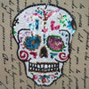 A white sequin skull embroidered patch featuring colorful gems and details for DIY clothing.