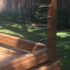 Close-up of marine-grade stainless steel cable used for a wooden railing system.