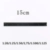 A black aluminum triangular scale ruler marked with a 15 cm measurement.