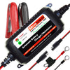 A black automatic battery charger and maintainer device with various cables and battery components.