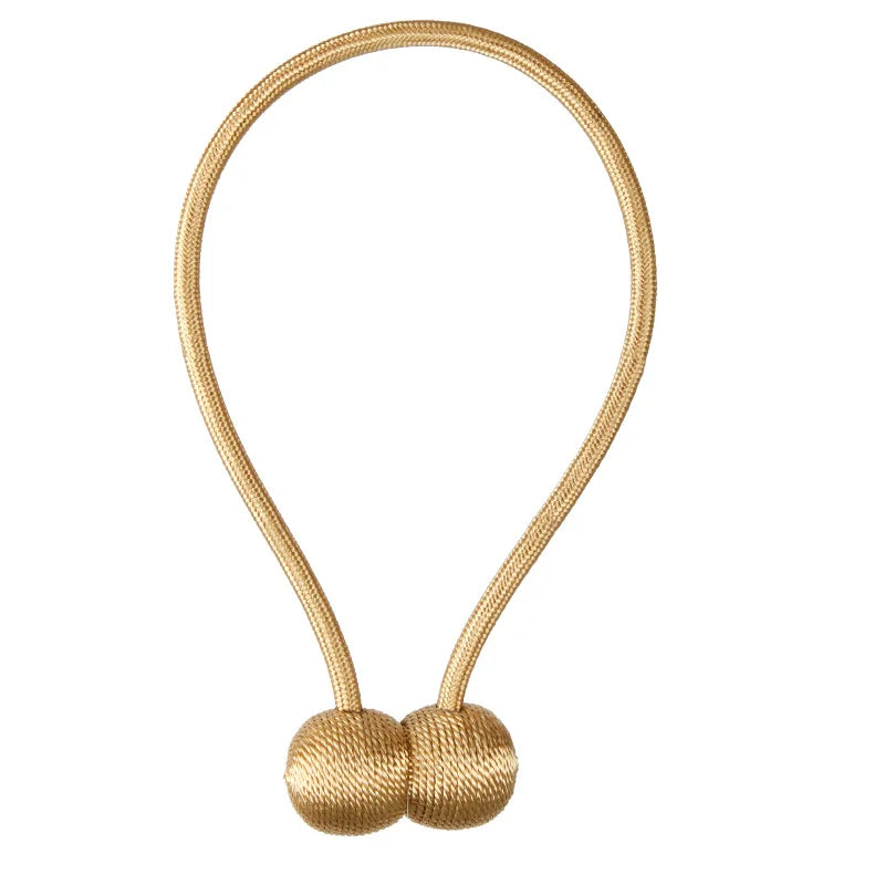 Gold-toned magnetic pearl ball curtain tiebacks with thin gold cord.