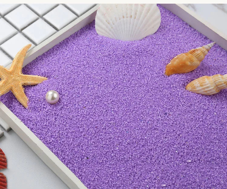 Purple decorative stone pebbles with a white seashell and starfish on a white tray