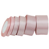 A roll of light pink satin ribbon, 1 inch wide and 25 yards long.