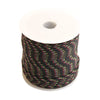 Roll of black paracord with yellow and red reflective strands on a white spool