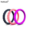 Three braided silicone rings in black, pink, and purple displayed against a white background.