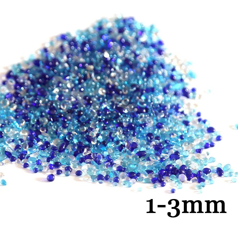 A pile of small, iridescent blue and purple decorative stone pebbles ranging from 1 to 3 millimeters in size.