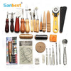 A collection of professional leather craft tools including needles, punches, and various shaping implements.