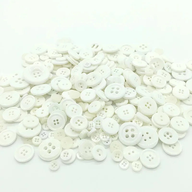 A pile of assorted white wooden buttons for sewing and crafts.
