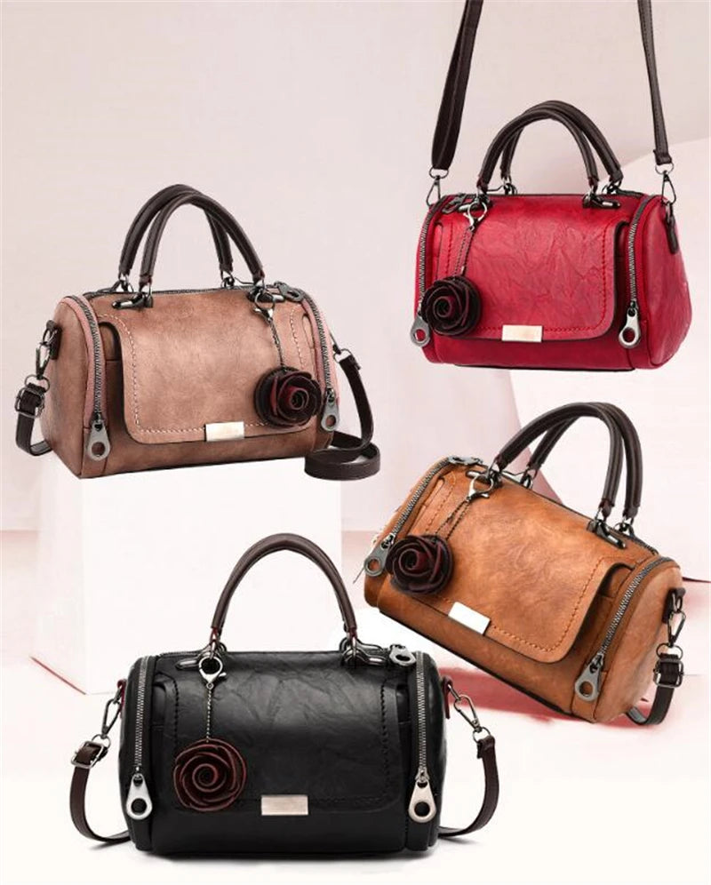 Three elegant women's crossbody shoulder bags in brown, red, and black leather with floral pendants.
