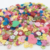 A colorful assortment of small wooden buttons in various shapes and colors for sewing and crafts.