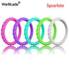 Five colored braided silicone rings in various shades of purple, green, and white.