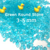 Bright blue round stones and yellow duck figurines for decorative use