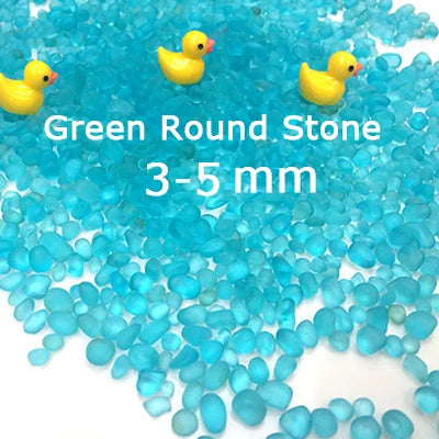 Bright blue round stones and yellow duck figurines for decorative use