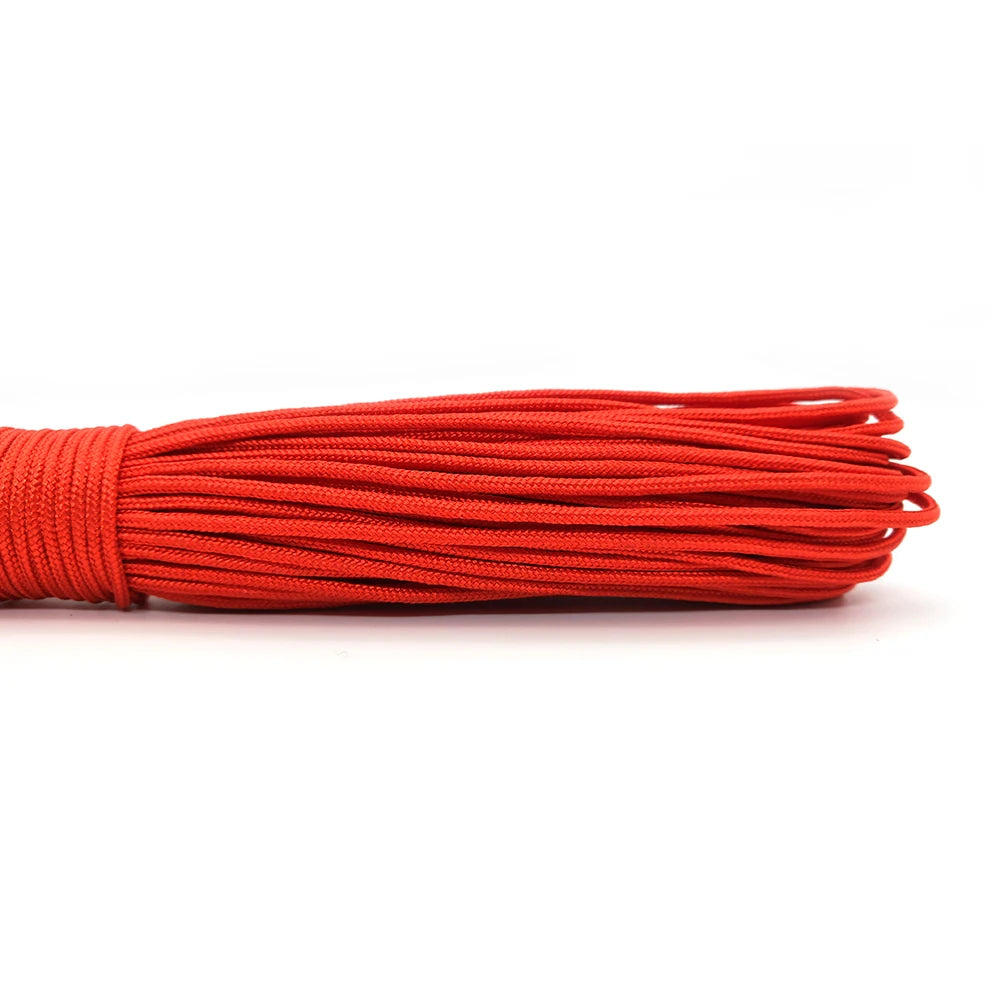 A bundle of red multi-color paracord rope laid horizontally against a white background.