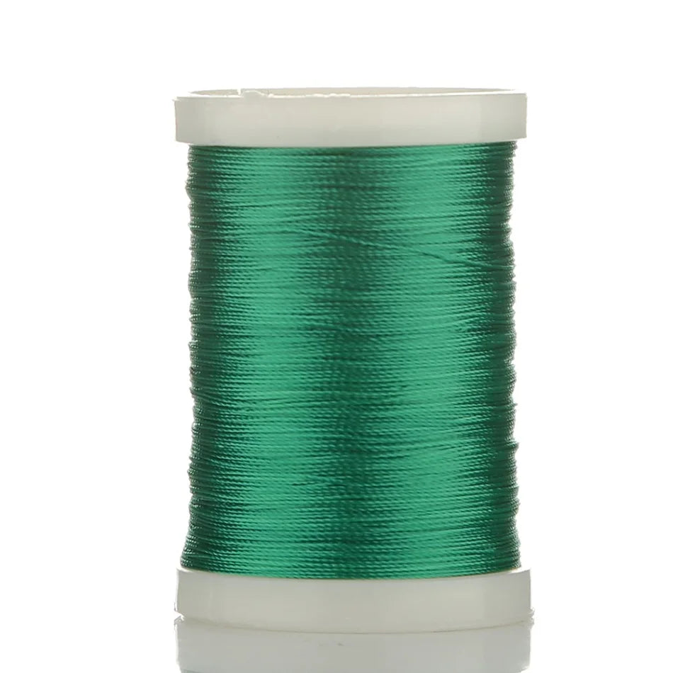 Spool of bright green braided polyester thread for guide tying and repairs