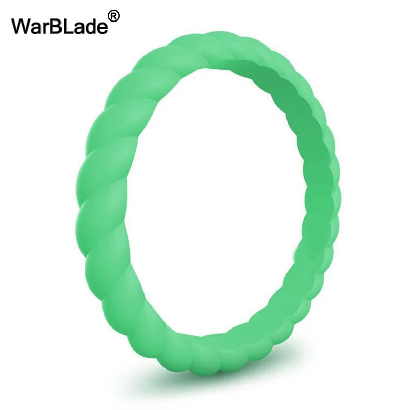 A close-up view of a smooth, green braided silicone ring.