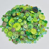 A pile of assorted eco-friendly wooden buttons in various shades of green, yellow, and blue.