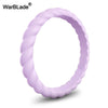 A close-up view of a lavender braided silicone ring.
