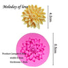 A pink silicone mold shaped like a flower, used for cake decorating.