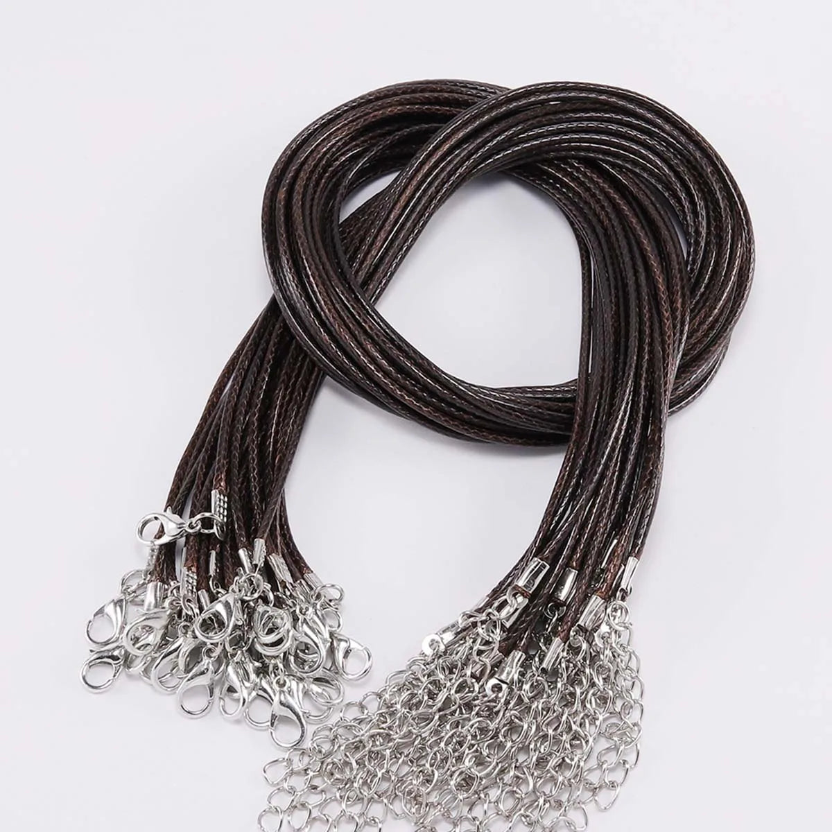 A coil of dark brown leather cord necklace with silver clasps