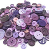 Assortment of eco-friendly wooden buttons in various shades of purple and pink for sewing and crafts