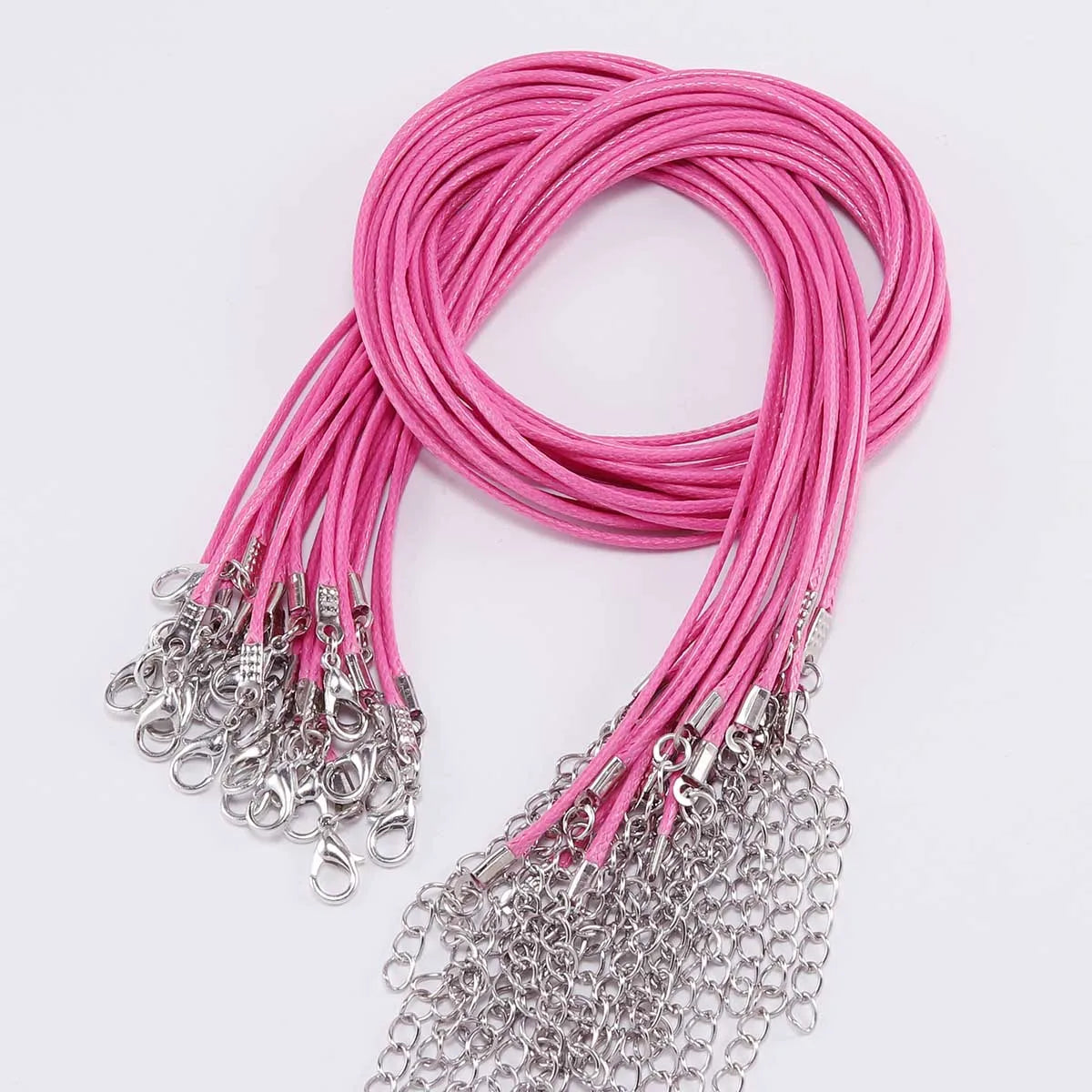 Pink adjustable leather cord necklace with silver clasps coiled and displayed