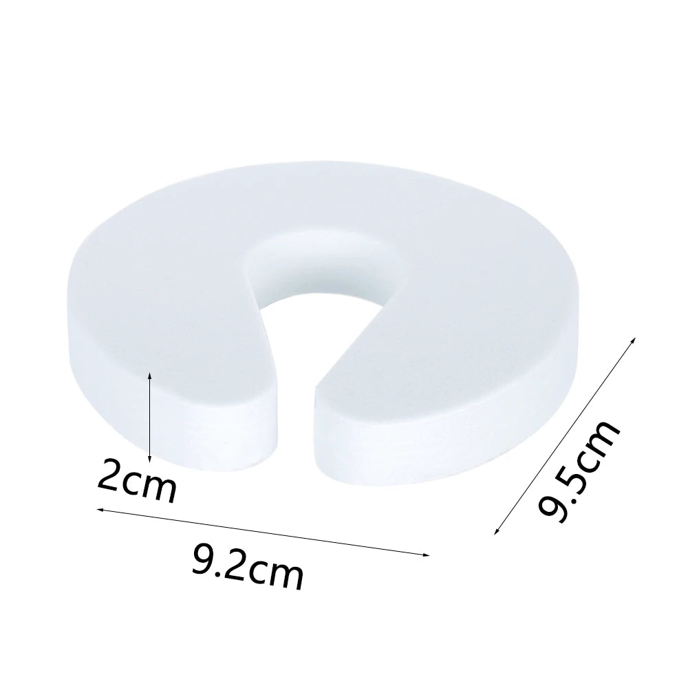 White foam door stopper with finger pinch protection, measuring 9.5cm in height and 9.2cm wide.
