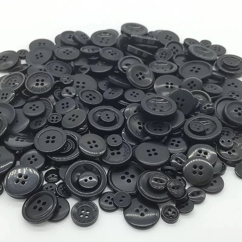 A pile of assorted black wooden buttons for sewing and crafts.