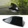 A black car shark fin antenna cover is shown in a close-up view against a dark car surface.