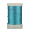 A spool of teal braided polyester thread for guide tying and repairs.