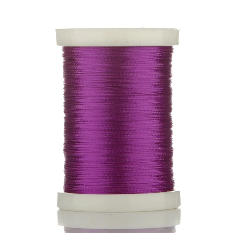 A spool of bright purple braided polyester thread for guide tying and repairs.