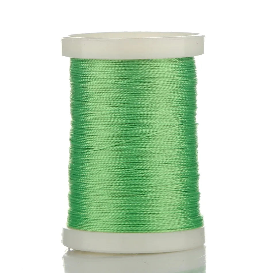 Green braided polyester rod wrapping thread on a spool for guide tying and repairs