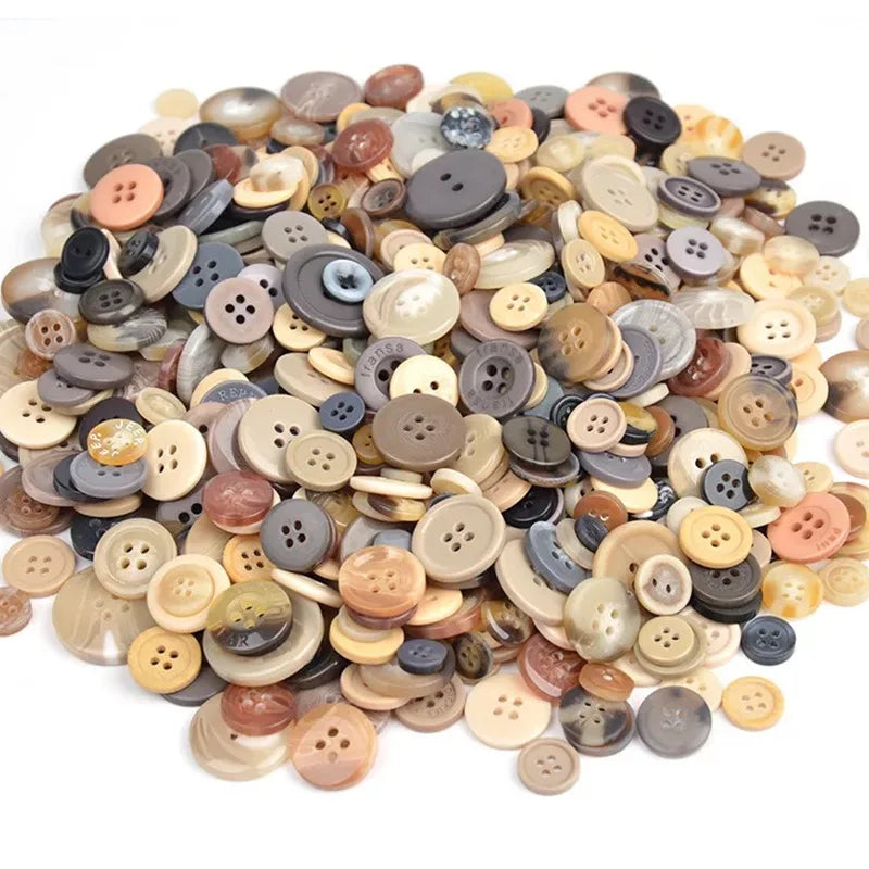 A pile of assorted natural wood and ceramic buttons in various shades of brown, beige, and gray.