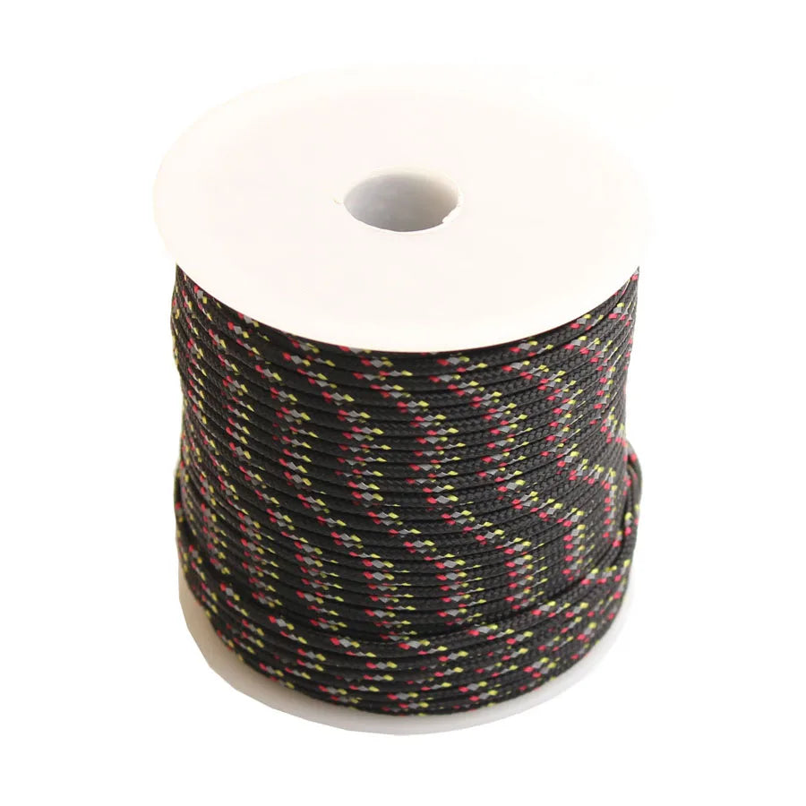 Roll of black paracord with yellow and red reflective strands on a white spool