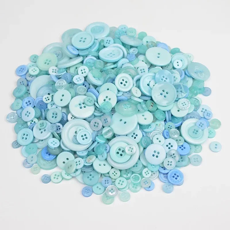A pile of assorted light blue and mint green wooden buttons for sewing and crafts