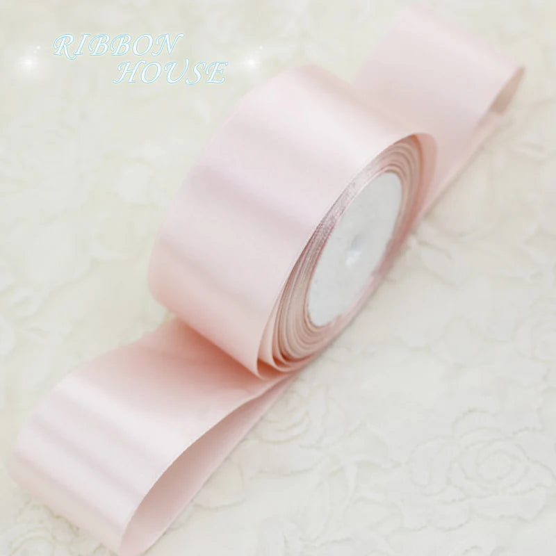 Roll of light pink satin ribbon measuring one inch wide and twenty-five yards long