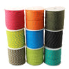 A stack of bright colored paracord spools in red, orange, yellow, blue, and green.