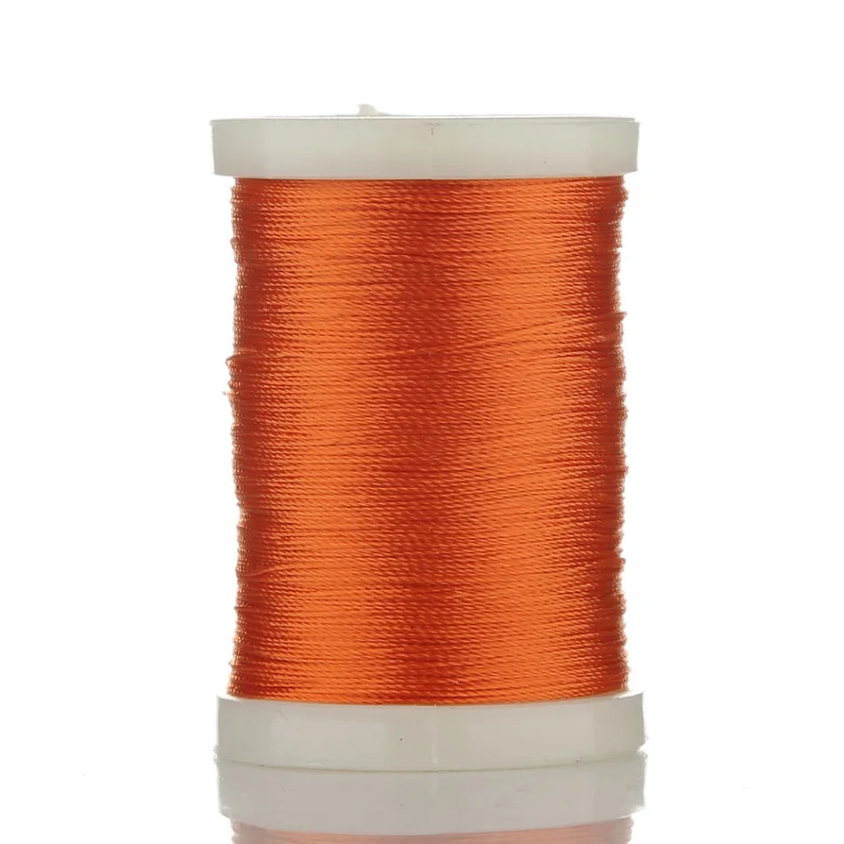 A spool of bright orange braided polyester thread for guide tying and repairs.