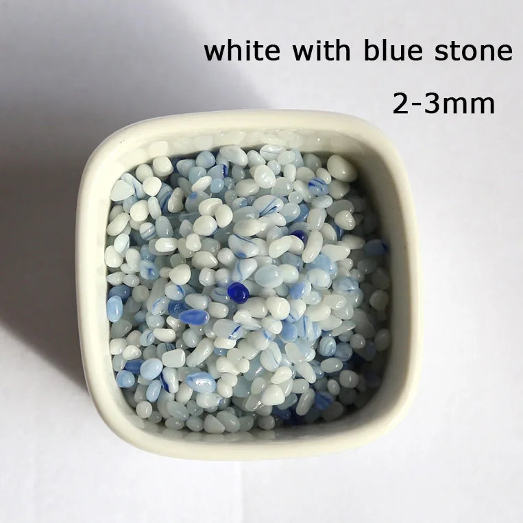 White with blue stone decorative pebbles measuring 2-3mm in a small container