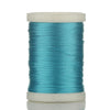 A spool of teal blue braided polyester thread for guide tying and repairs.