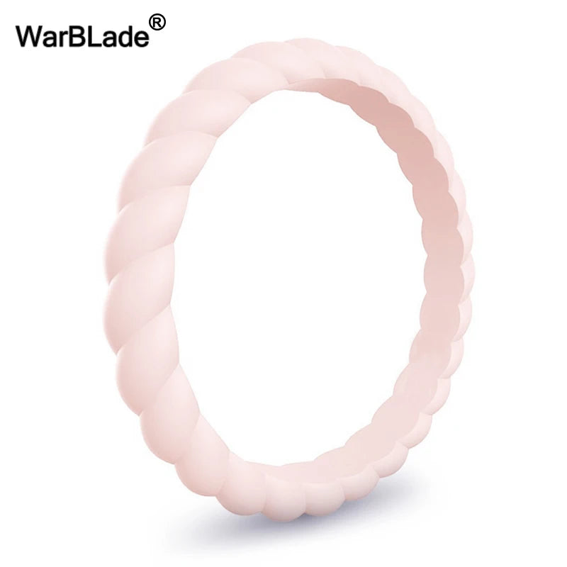 A close-up view of a pink braided silicone ring, designed as a hypoallergenic and sport-friendly wedding band.