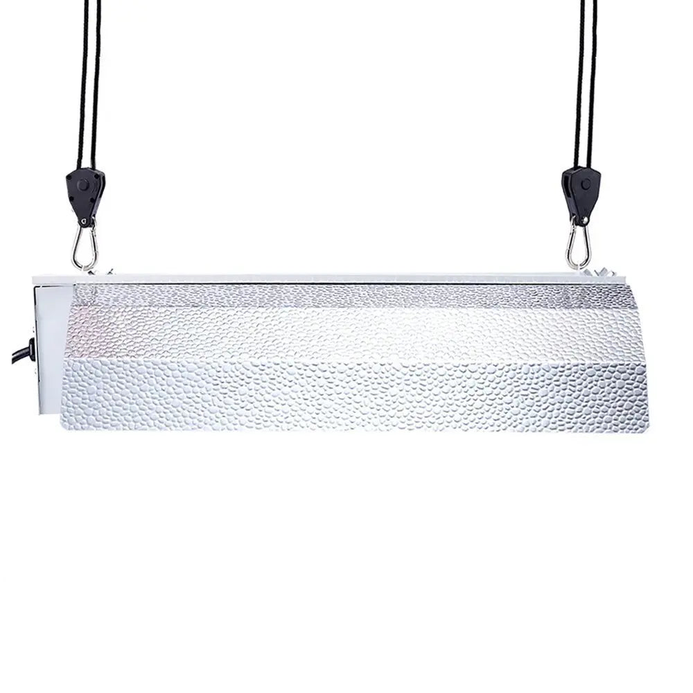 A silver metal light fixture or panel is suspended by black rope clips.