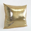 A square metallic gold decorative pillowcase with a shiny finish.