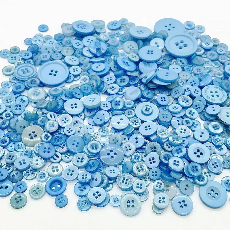 A pile of assorted light blue and sky blue wooden buttons for sewing and crafts