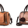 A tan leather crossbody shoulder bag with a floral pendant and dark brown strap.