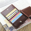 A brown leather money clip wallet with magnetic closure is shown open, displaying several cards and cash inside.