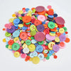 A colorful assortment of round wooden buttons in various shades of pink, yellow, green, and blue.