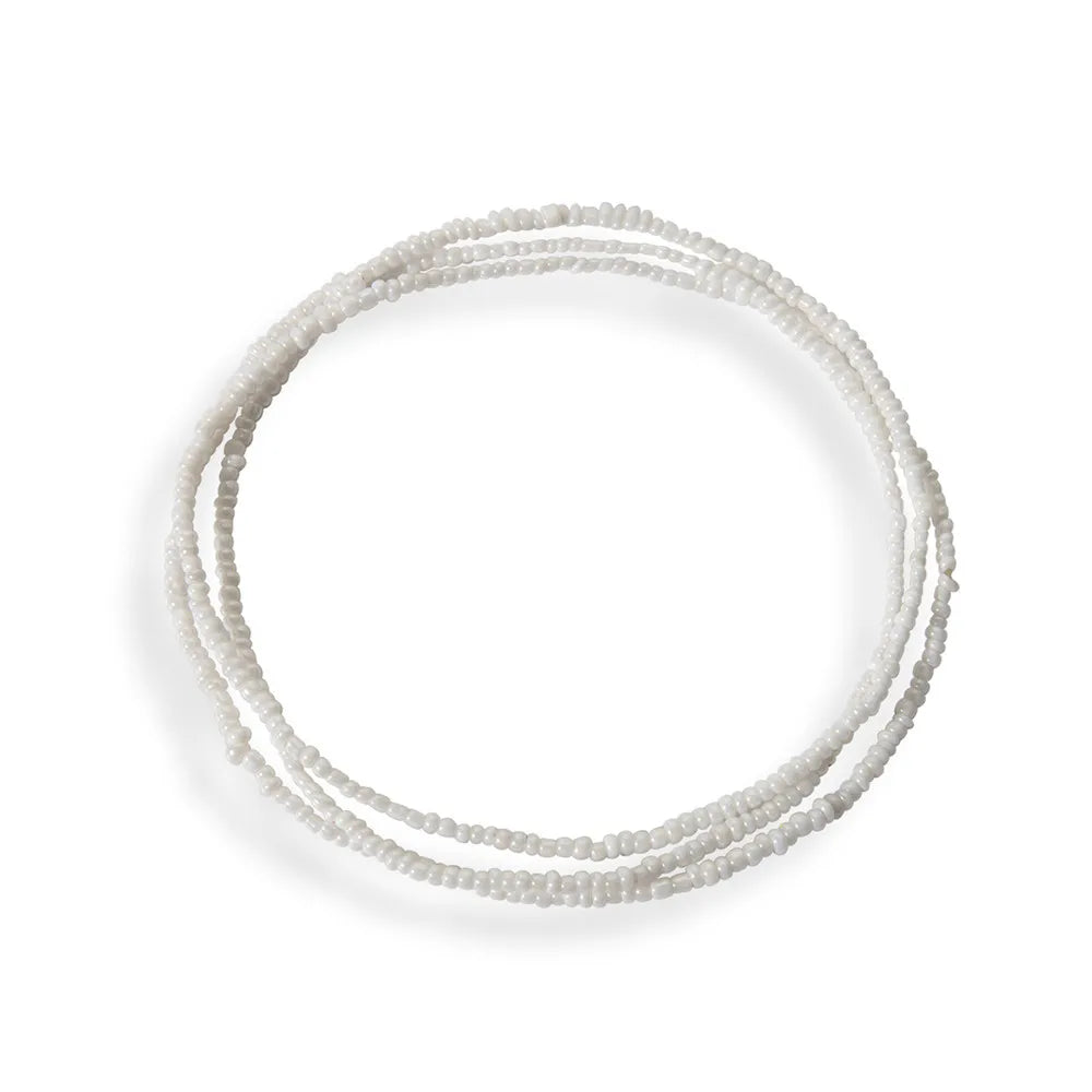 A delicate strand of small, light-colored beads forming an elastic waist chain.