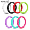 A collection of braided silicone rings in various colors including black, white, red, and lime green.