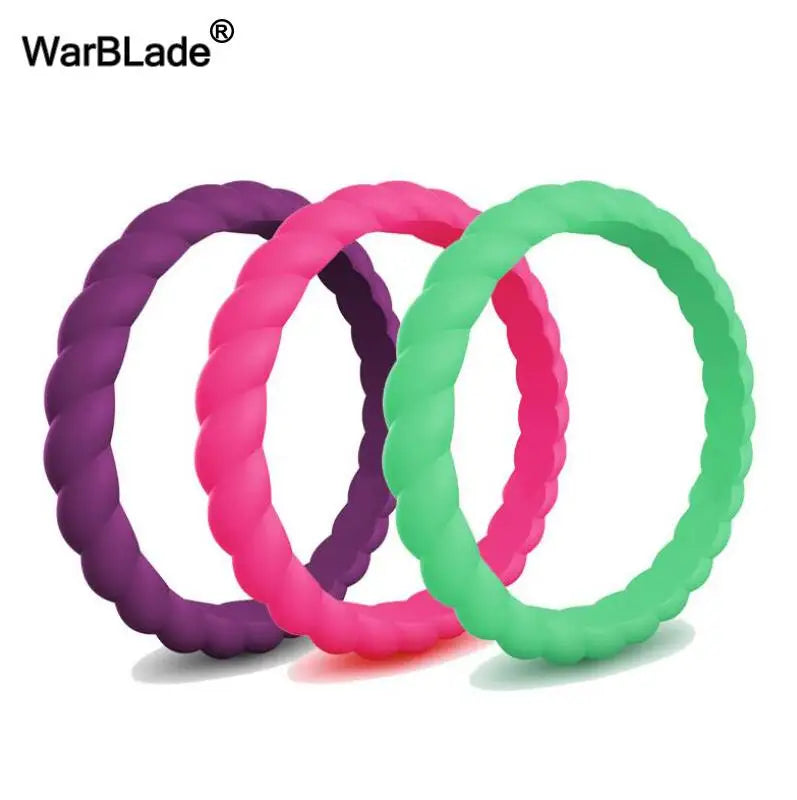 Three braided silicone rings in purple, pink, and green displayed together.